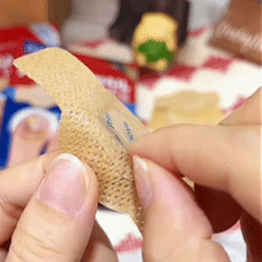 Demonstration of peeling the release liner from a nail care patch